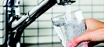 photo of glass of water under running sink spiket